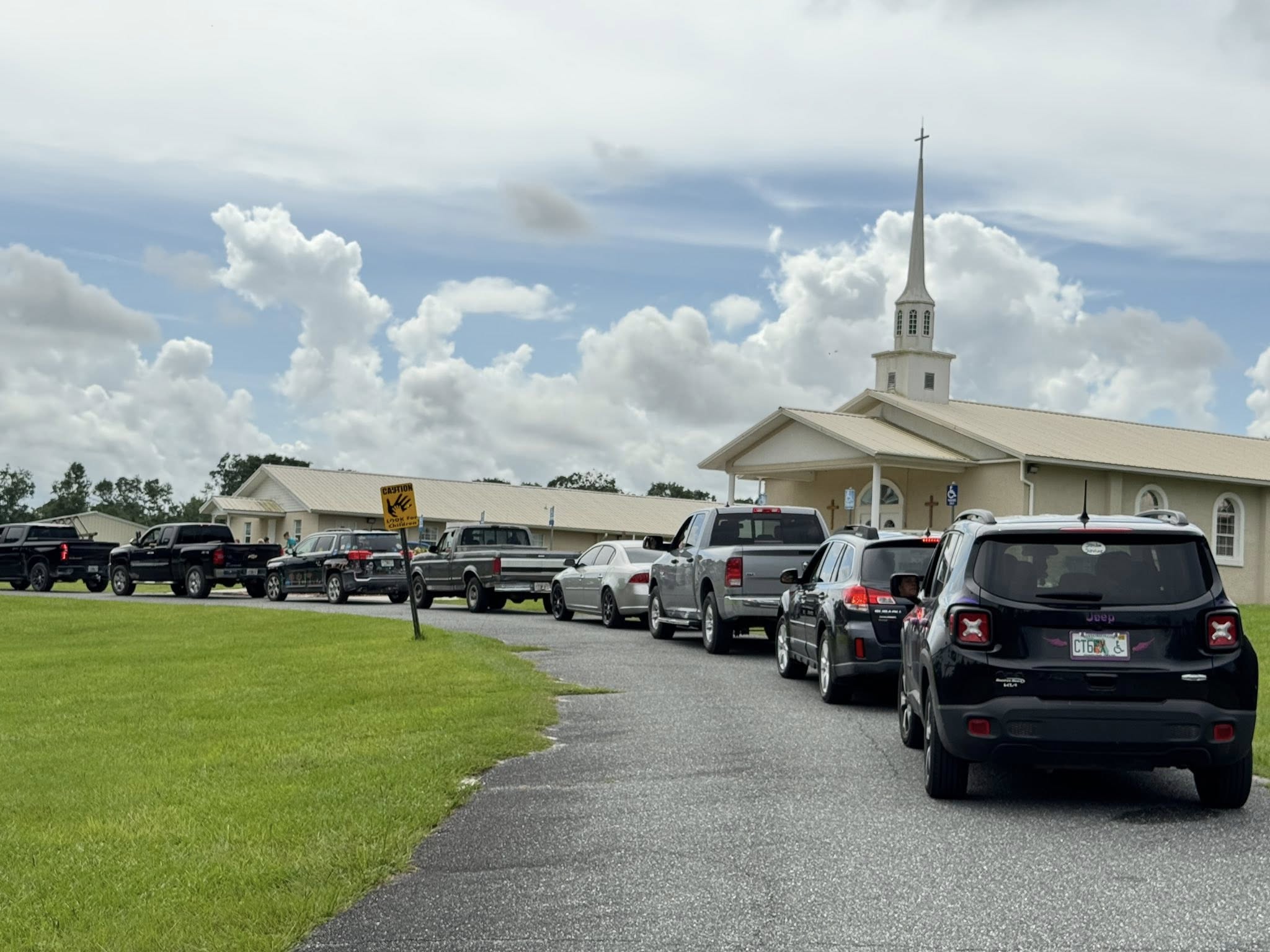 Friendship Baptist Church building with cars parked out front